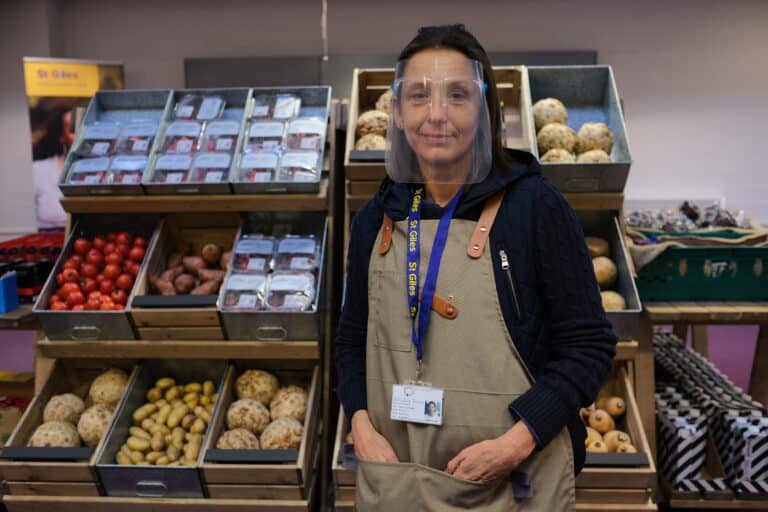 a person wearing a face shield and apron