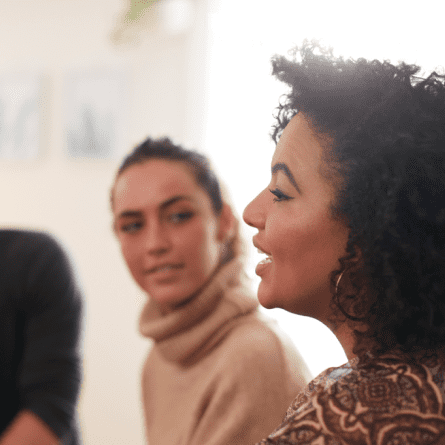 Woman Speaking At Group Meeting