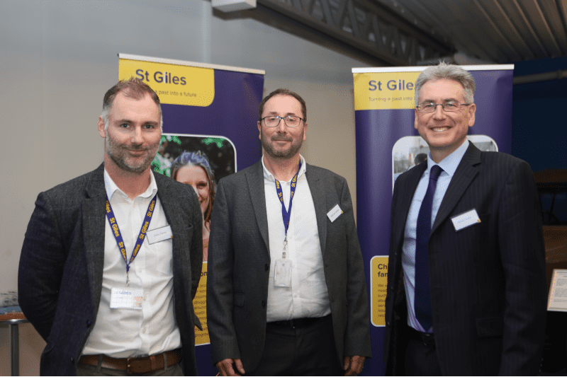 Photograph of Steve Clarke, Malcolm Walker, Simon Foster stood in front of St Giles banners.