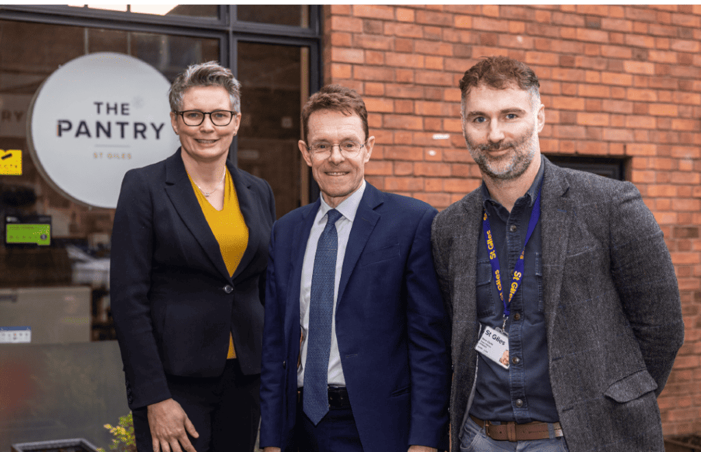 Photograph of Tracey Burley (St Giles CEO) Andy Street (West Midlands Mayor) and Steve Clarke ( St Giles Midlands Head of services) stood out side the St Giles Midlands Pantry.