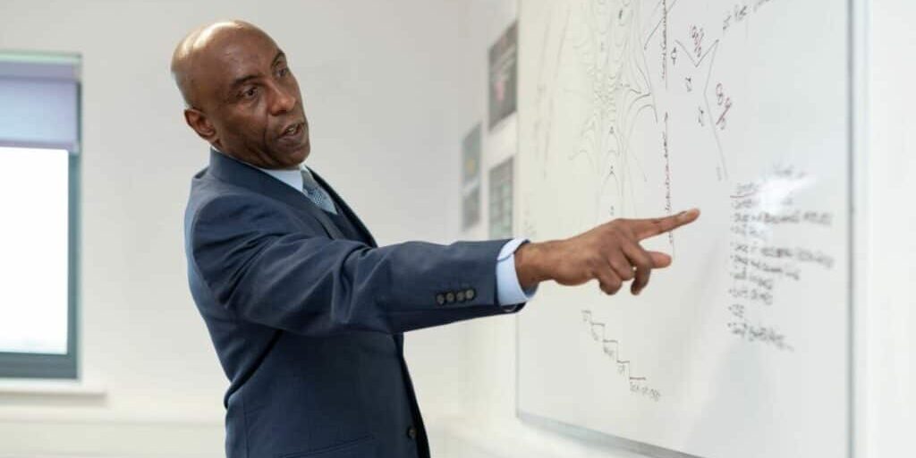 A person pointing at a whiteboard