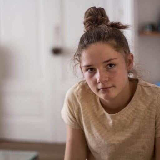 A thoughtful teenager in a calm and shabby interior